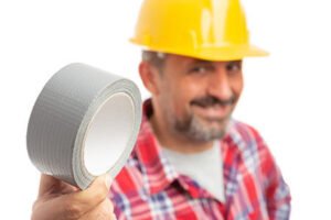 A man holding double sided adhesive tape